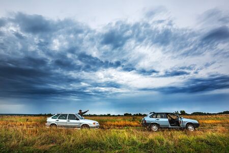 Suzun district, Novosibirsk region, Western Siberia, Russia - August 21, 2018: Russian cars among the grass in the meadowのeditorial素材