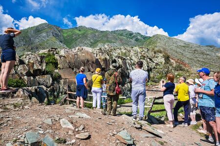 Petroglyph complex "kalbak - Tash" (ritual sanctuary), Ongudai district, Altai Republic, Russia - July 15, 2019: tourists watch rock paintingsのeditorial素材