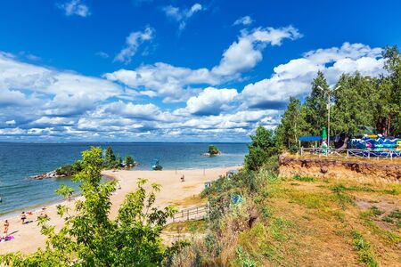 Ob reservoir, Berdsk, Novosibirsk region, Western Siberia, Russia - August 10, 2019: city recreation Park and beach "On the rocks"のeditorial素材