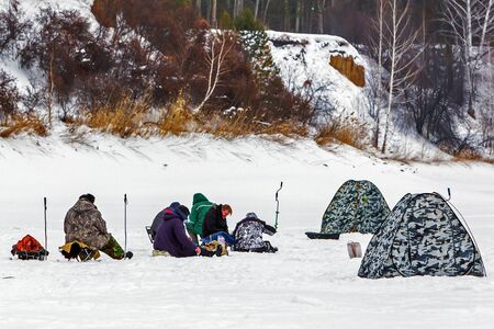 Razdelnaya river, Berdsk, Novosibirsk region, Western Siberia, Russia-February 23, 2020: Fishermen with winter tents on a snow-covered riverのeditorial素材