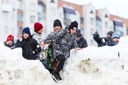 Berdsk city, Novosibirsk region, Western Siberia, Russia-March 1, 2020: Children on the snow fortress on the Maslenitsa holidayのeditorial素材