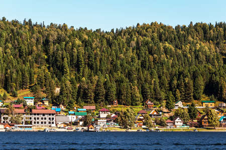 View of the village of Artybash, lake Teletskoye and mountains covered with coniferous taiga. Turochaksky district, Altai Republic, South of Western Siberia, Russiaのeditorial素材