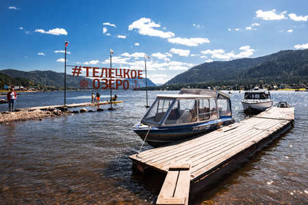 Artybash village, Turochaksky district, Altai Republic, Russia-August 20, 2020: Pier and pleasure boats in the village of Artybash on lake Teletskoyeのeditorial素材