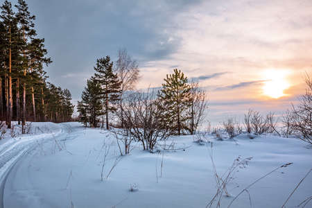 Winter sunset on the coast of the Ob Sea. Western Siberia of Russia