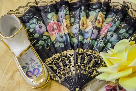 Floral fan with ceramic decoration and yellow flowerの写真素材