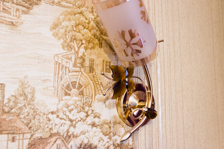 pictured in the photo vintage wall lamp beautifol decorated with plastic bow tieの写真素材