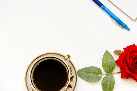 Cup of coffe and open notebook on white backgroundの写真素材