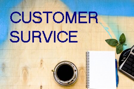 Cup of coffe and open notebook on wooden backgroundの写真素材