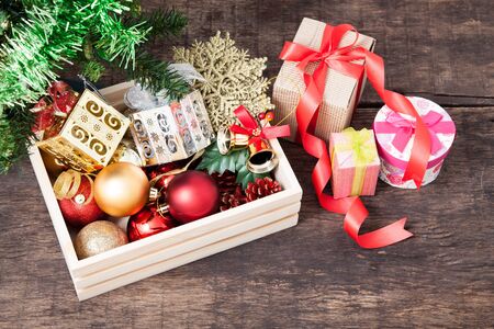 Box filled with Christmas decorations on wooden tables topの写真素材