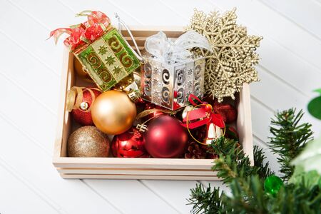 Box filled with Christmas decorations on white backgroundの写真素材