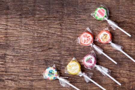 Colorful lollipop on wodden table topの写真素材