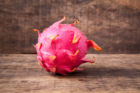Fresh red dragon fruit with cut dragon fruit and slice on wooden backgroundの写真素材