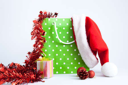 Isolated green polka dot paper shopping bag on white background with decorationの写真素材