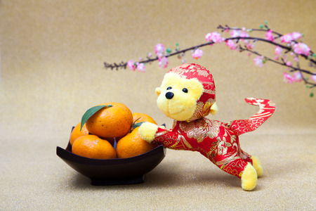 2016 is year of the monkey decorate with mandarin orange and plum blossom for chinese new yearの写真素材