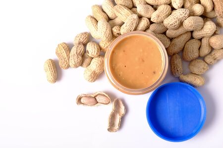 peanut butter in jar and  peanuts with space for text isolated on white background
