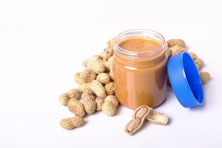 peanut butter in jar and  peanuts with space for text isolated on white backgroundの写真素材