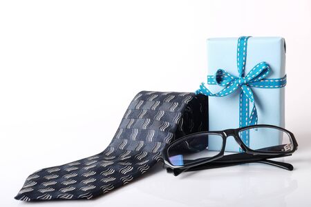 Gift box, necktie and glasses with space for taxt isolated on white background. Concept for fathers day.の写真素材