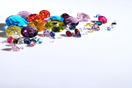 Colorful of different gemstones with space for text on white background: amethyst, citrine, ruby and topaz.の写真素材