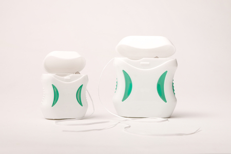 Dental care; Dental floss on white background.のeditorial素材