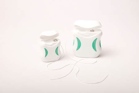 Dental care; Dental floss on white background.のeditorial素材