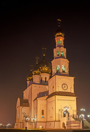 Night photo of an orthodox cathedral. Golden domes in the light of street lamps.の写真素材