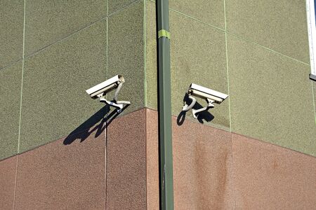 Several outdoor surveillance camera mounted on the wall of the house.の写真素材