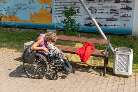 Homeless, alcoholic woman sleeping on a benchのeditorial素材