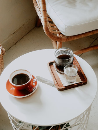 Coffee cup and saucer on white table in coffee shop