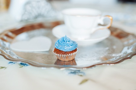 Retro stylized photo of muffin with a cup of coffee for breakfast