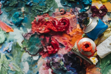 Artists brushes and oil paints on wooden palette.の写真素材