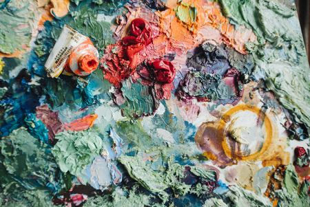 Artists brushes and oil paints on wooden palette.の写真素材