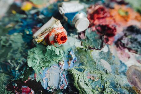 Artists brushes and oil paints on wooden palette.の写真素材