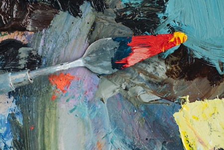 Professional acrylics orange paint on canvas and loaded palette knife.の写真素材