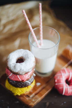 Colourfull donuts and glass of milk close up.の写真素材