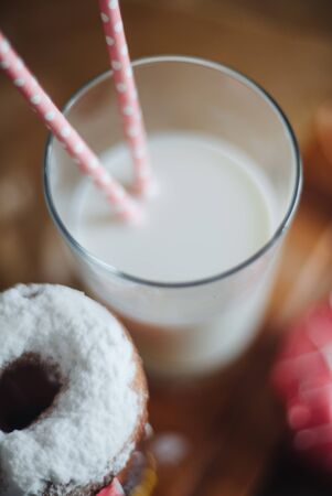 Colourfull donuts and glass of milk close up.の写真素材