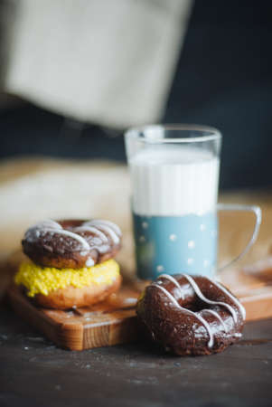 Colourfull donuts and glass of milk close up.の写真素材