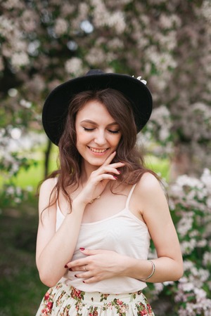 portrait of young lovely woman in spring flowersの写真素材