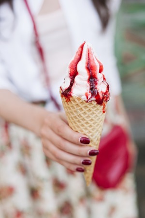 Woman hands holding fruity ice cream in hands