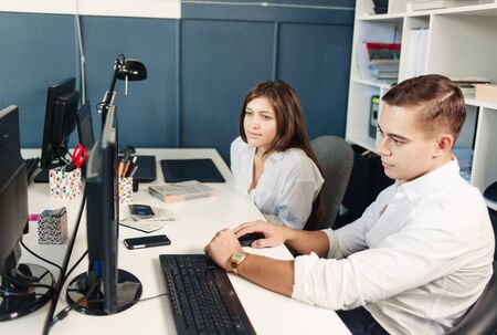 Couple of young designers working at modern officeの写真素材