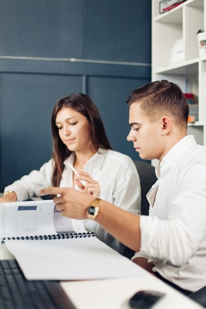 Couple of young designers working at modern officeの写真素材