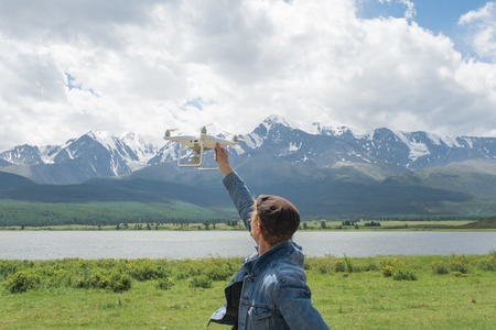 Man controling a drone on mountain background.の写真素材