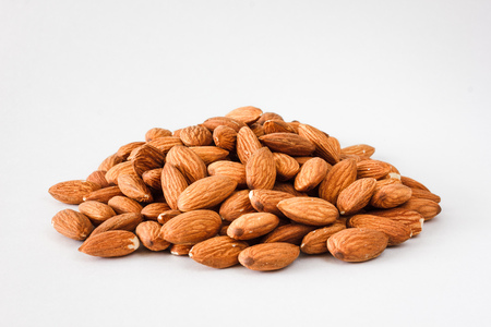 Nuts and honey photoset. A handful of almonds isolated on a white backgroundの写真素材