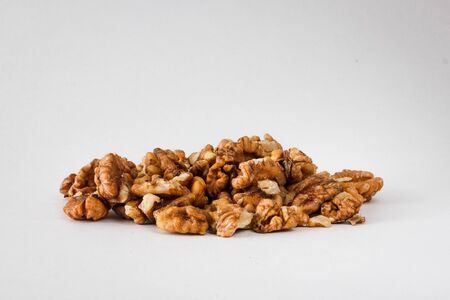 Nuts and honey photoset. A handful of walnuts isolated on a white backgroundの写真素材