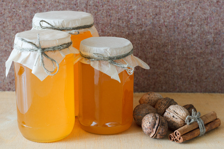 Nuts and honey photoset. Honey, walnut, cinnamon, sawed wood.の写真素材