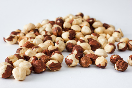 Nuts and honey photoset. A handful of hazelnuts isolated on a white backgroundの写真素材