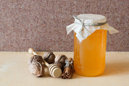 Nuts and honey photoset. Honey, walnut, cinnamon, sawed wood.の写真素材