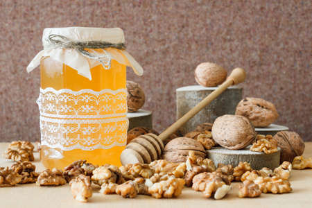 Nuts and honey photoset. Honey, walnut, sawed wood.の写真素材