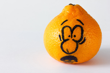 Emotion faces on mandarins photoset. Frightened face.の写真素材