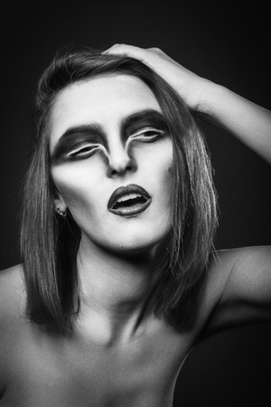 Raven woman photoset. Woman with raven make up portrait.の写真素材