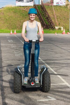 Young lady in a helmet riding on a hover vehicle.の写真素材